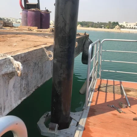 Engineer checking pipeline vertical alignment using measuring tools