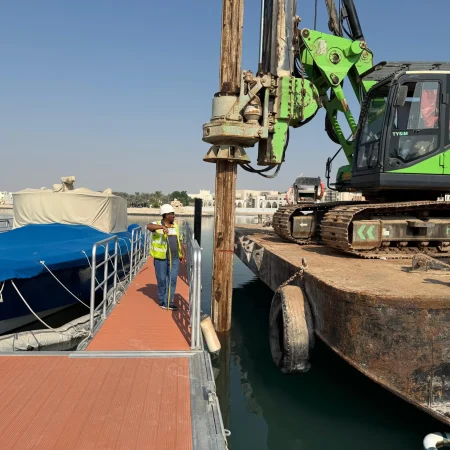 Marine pipeline installation with piling rig and crew alignment works at port