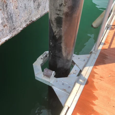 Engineer checking pipeline vertical alignment using measuring tools
