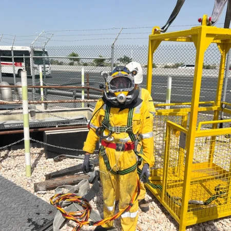 Confined-space marine maintenance works at Muntazah Road Underpass involving commercial divers, lifting cage, and removal of submersible pumping equipment.