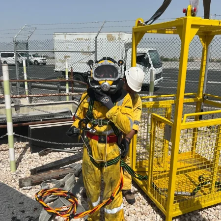 Confined-space marine maintenance works at Muntazah Road Underpass involving commercial divers, lifting cage, and removal of submersible pumping equipment.