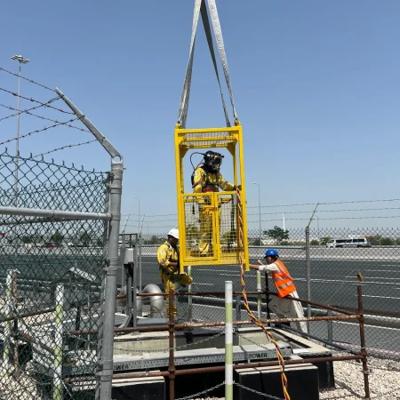 Confined-space marine maintenance works at Muntazah Road Underpass involving commercial divers, lifting cage, and removal of submersible pumping equipment.