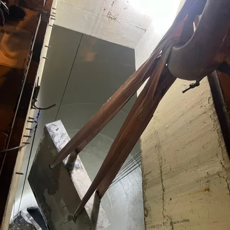 Confined-space marine maintenance works showing lifting cage, rigging systems, slab removal, and inspection activities during pipeline and MISW intervention.