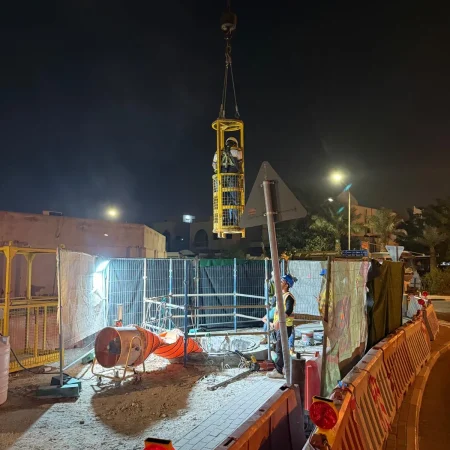 Confined space mechanical works at PS30 showing core drilling and installation of 1000mm diameter air recirculation duct within reinforced concrete shaft.